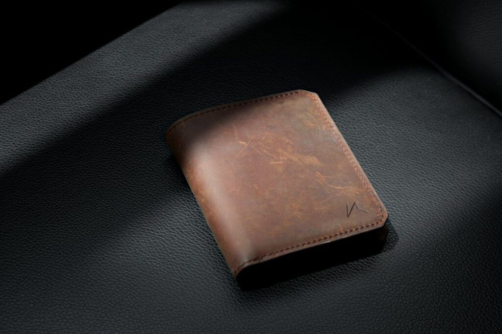 Aged full-grain leather wallet with a darker patina from years of use